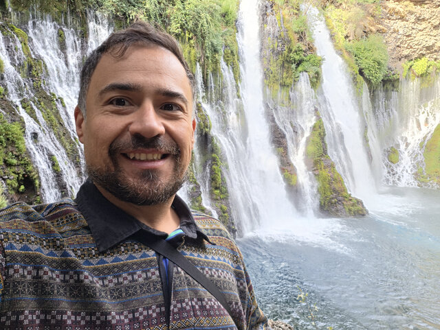 Jam Garcia beside a waterfall